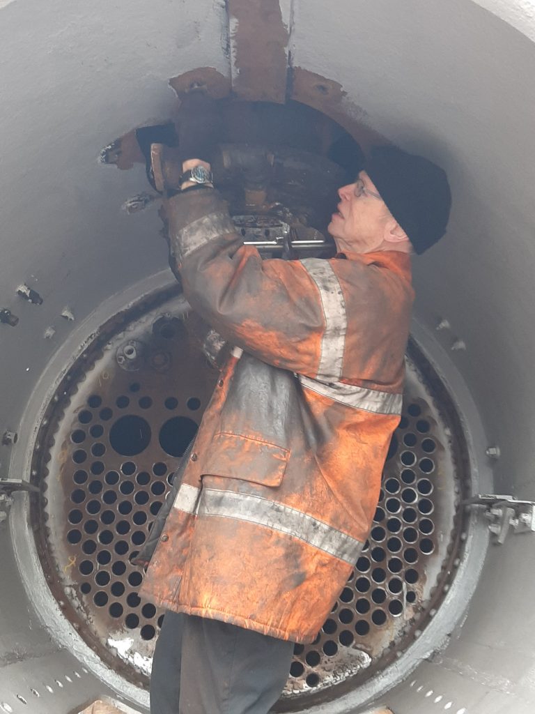 John Dixon fixes lifting chains below 5643's chimney