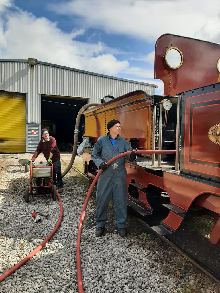 John and Jon in action with the hose and water pump