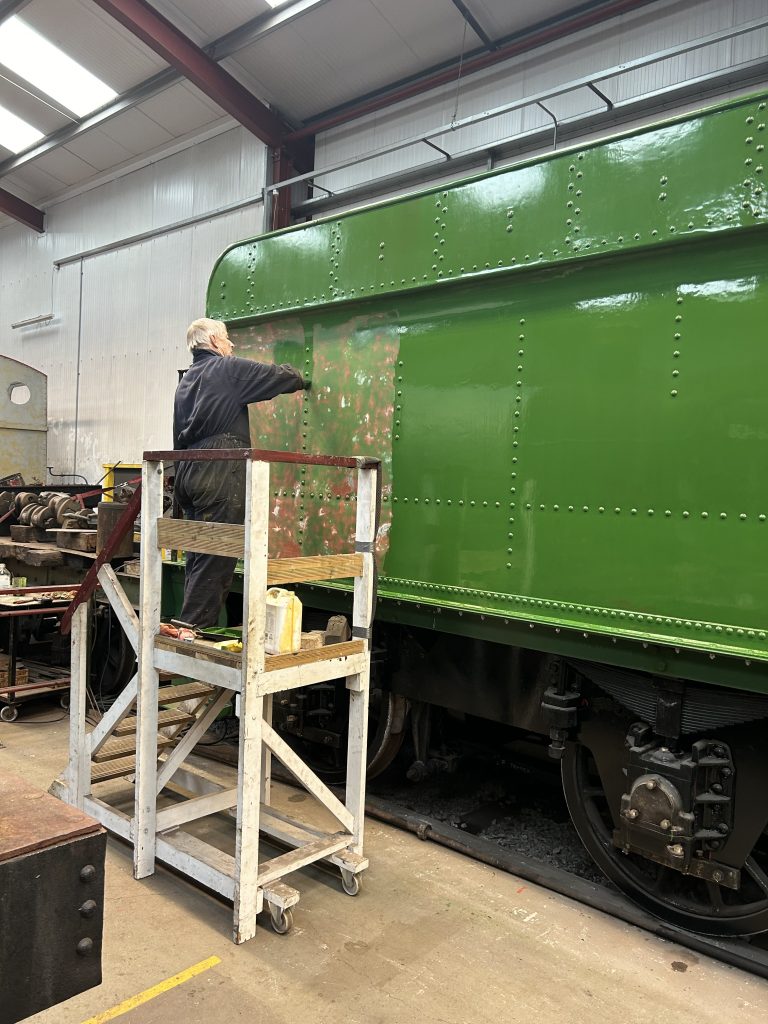 Tim applying a second coat of undercoat to the left hand of Wootton Hall's tender tank.