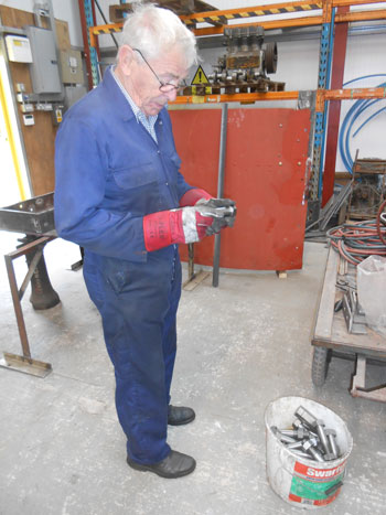 Bill inspecting bolts and nuts