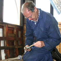 John Dixon glueing a patch ready to be screwed into the interior of the external panels
