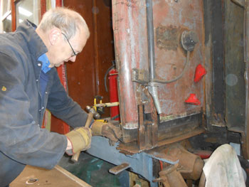 John chipping out corroded metal from the RMB
